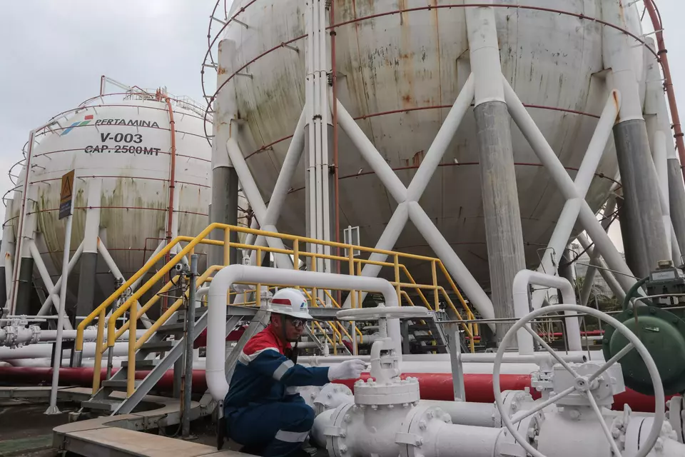 An employee of Pertamina inspects a pipeline